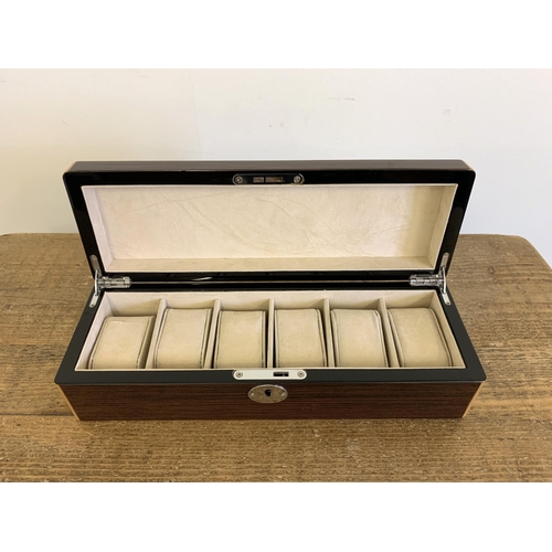 215 - A very good wood effect watch case to take six watches, 13