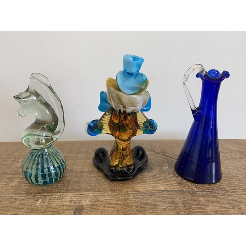 27 - A Mdina glass sea horse plus a Murano clown and a Mary Gregory style blue glass jug