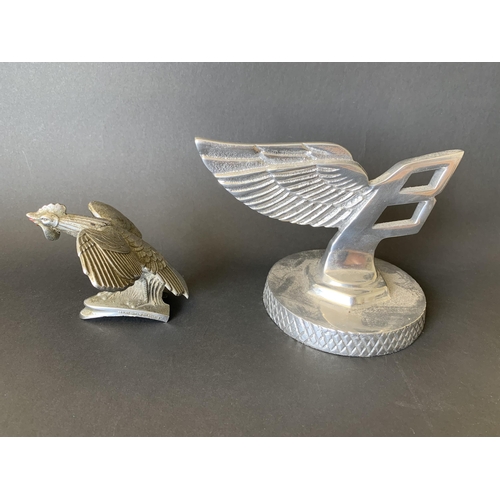 47 - A vintage white metal Bentley car mascot plus a vintage Singer bantam cockerel car mascot with regis... 