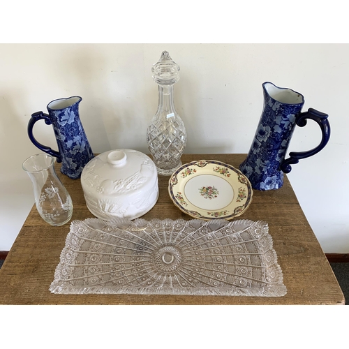 178 - A box of ceramics and glass including two blue jugs, cut glass decanter and a heavily cut tray etc