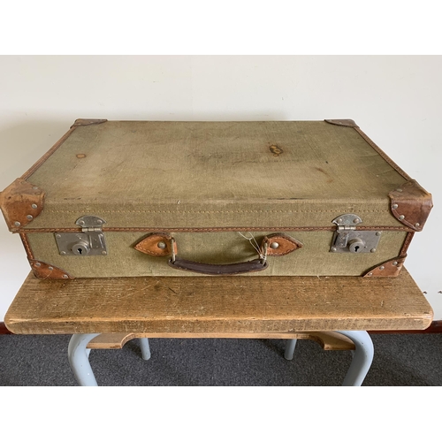 188 - A vintage canvas and leather suitcase, 25