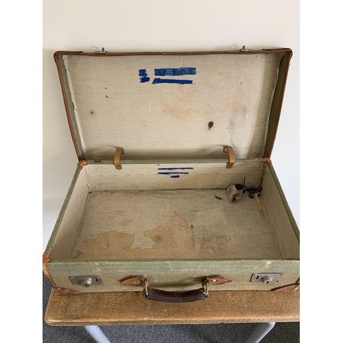 188 - A vintage canvas and leather suitcase, 25