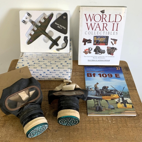 189 - A mixed military Lot including two WW2 civilian gas masks, one boxed, an Atlas boxed Short Sterling ... 