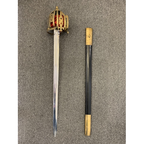 194 - A replica of a Scottish basket hilt sword in scabbard, length of blade 33