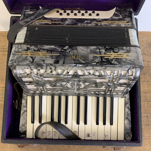 215 - A vintage cased 'Royal Artist' accordion (signs of use and wear)