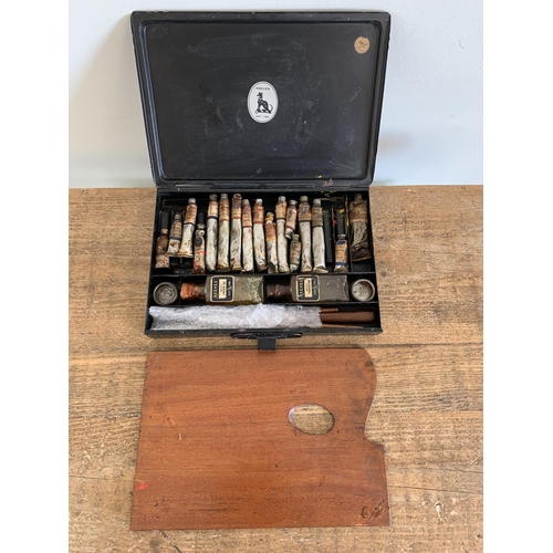 223 - A vintage 'Reeves' metal case artists set with old oils and wood palette and brushes together with a... 