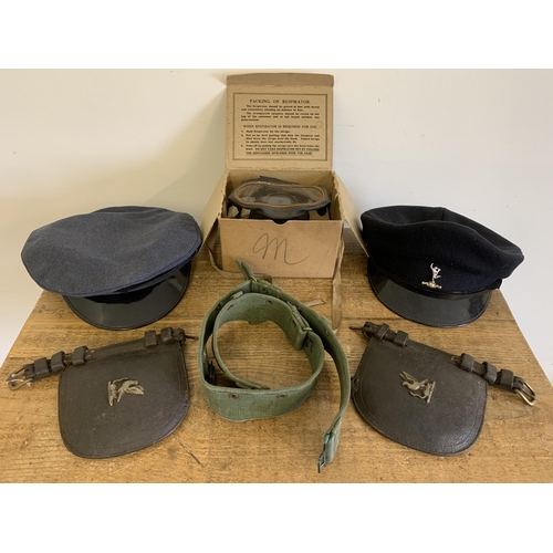 248 - A selection of military themed items including two caps, gas mask (as found), horse blinkers etc