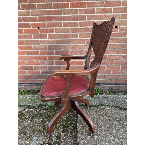 311 - An antique J.S.Ford Johnson and Company Chicago U.S.A. oak revolving office armchair with red leathe... 