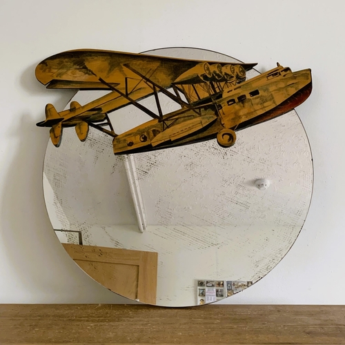 312 - A round wall mirror with cut out wood aeroplane attached, 24