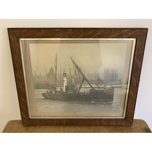 319 - A vintage oak framed and glazed photograph of Lowestoft trawler 'Commerce' LT977, from H Jenkins Stu... 