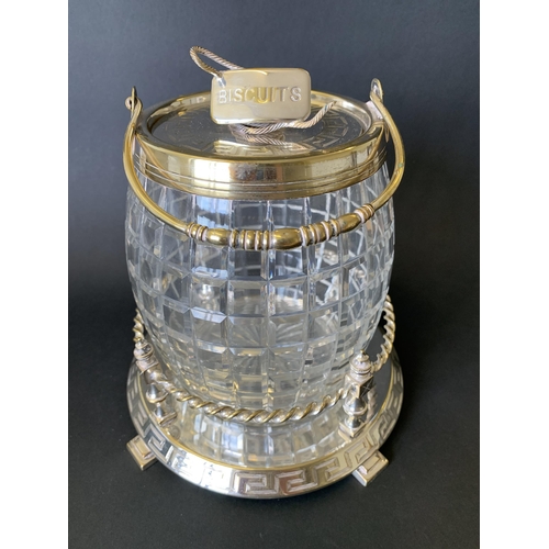 344 - A vintage silver plate and cut glass biscuit barrel on stand finished with a coiled rope handle (wea... 