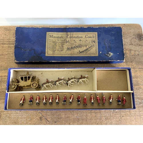 36 - A vintage miniature Coronation coach with lead figures