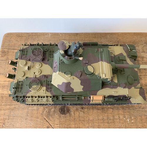 57 - A 'Taigen' self assembly radio controlled die cast tank with controller, approx. 21 1/2