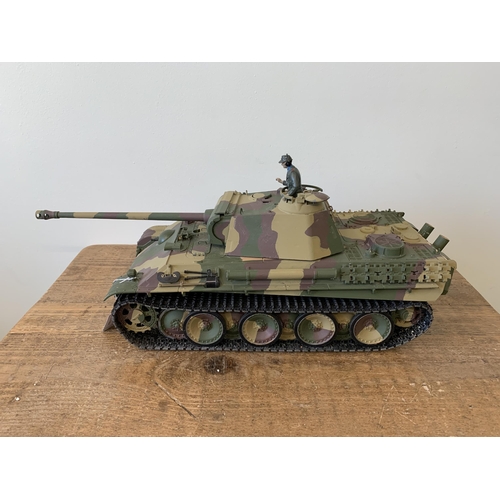 57 - A 'Taigen' self assembly radio controlled die cast tank with controller, approx. 21 1/2