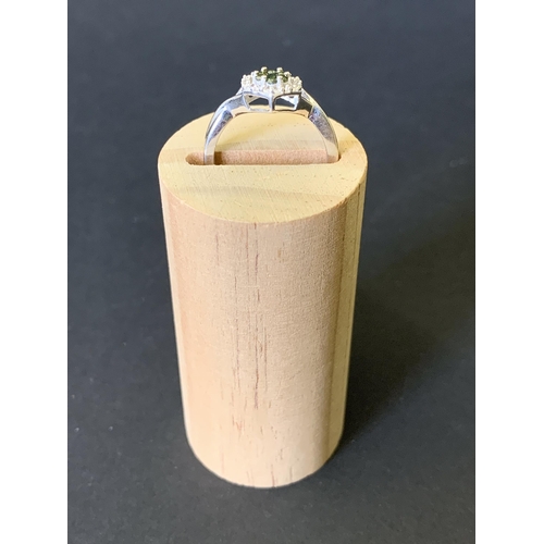 97 - A 9ct gold ring set with diamonds (the outer and inner green stones both testing as diamonds) approx... 