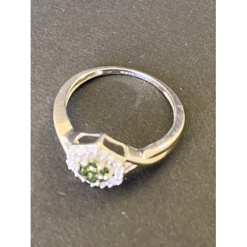 97 - A 9ct gold ring set with diamonds (the outer and inner green stones both testing as diamonds) approx... 