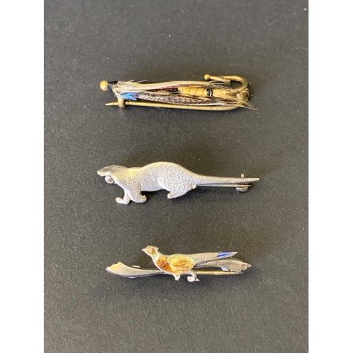 99 - A hallmarked silver and enamel pheasant brooch, a silver otter brooch and a brass Country Pursuits f... 