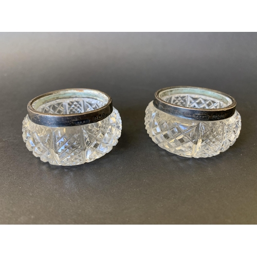 117 - A pair of hallmarked silver rim and cut glass salts plus a boxed set of vintage enamelled waistcoat ... 