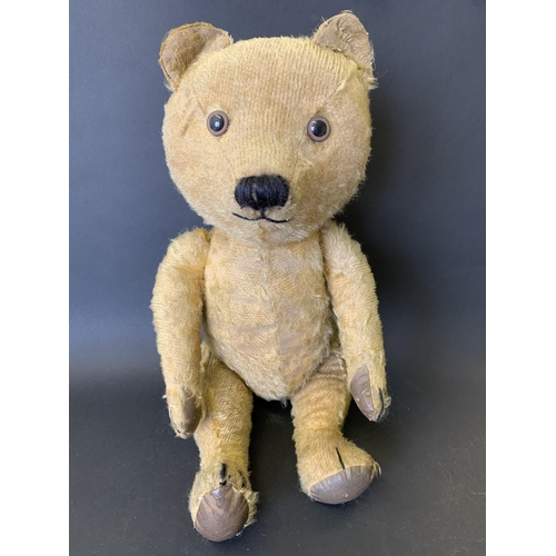 211 - A vintage mohair teddy bear with jointed limbs, glass eyes and leather pads, approx. 19