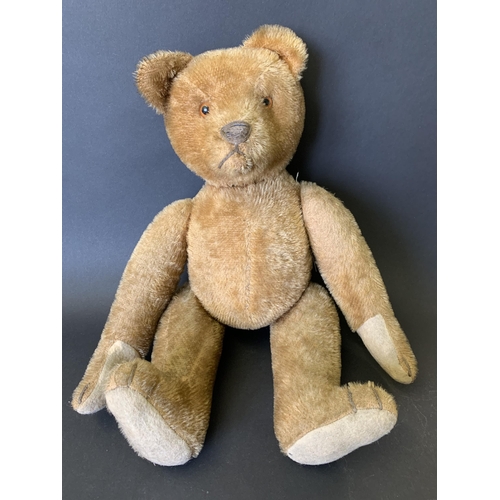 212 - A vintage mohair teddy bear with jointed limbs, glass eyes, felt pads, hump to back and former growl... 