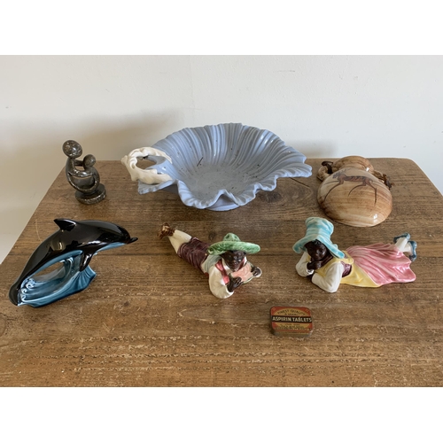 215 - A pair of vintage continental laying down figurines (she with as found foot) plus a Poole dolphin, f... 