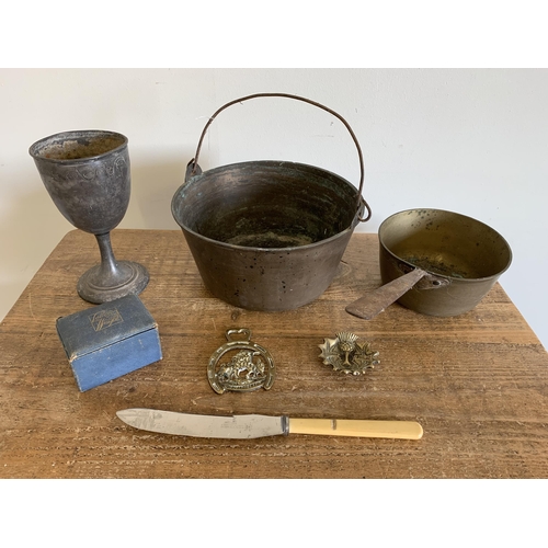 220 - A large brass pan, saucepan (both with rust), a white metal goblet etc