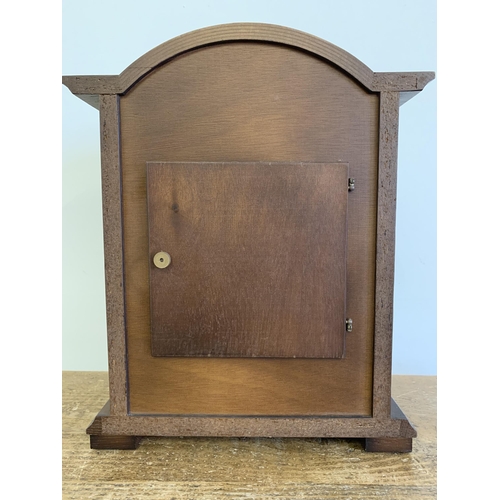 27 - A wooden cased mantel clock converted to battery, German face, 12 1/2