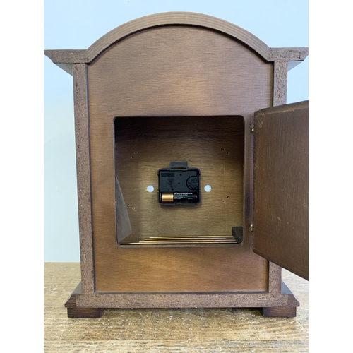 27 - A wooden cased mantel clock converted to battery, German face, 12 1/2