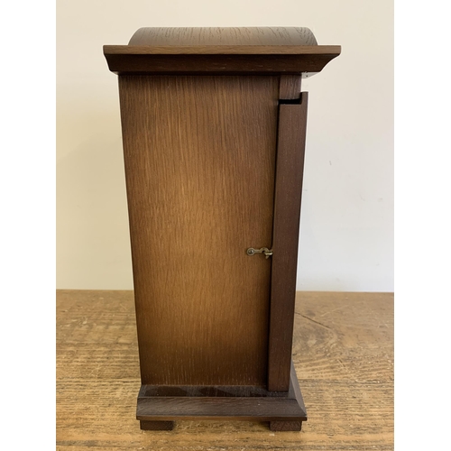 27 - A wooden cased mantel clock converted to battery, German face, 12 1/2