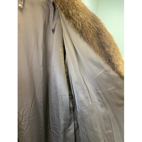 36 - A vintage knee length fur coat, lacking labels, medium sized