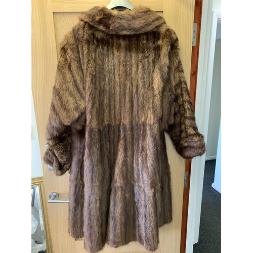 36 - A vintage knee length fur coat, lacking labels, medium sized