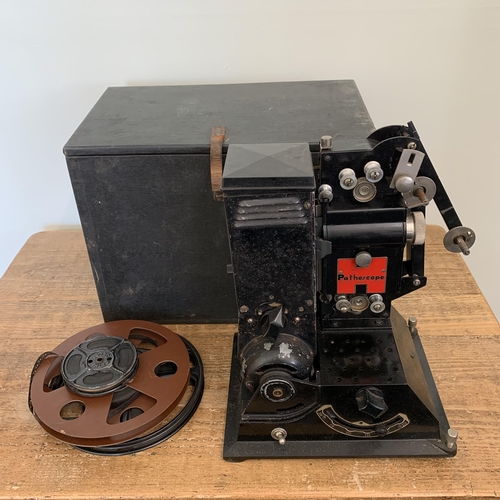 425 - A boxed vintage Pathescope 'H' cine projector 9.5mm, circa 1930's with two large and one small film ... 