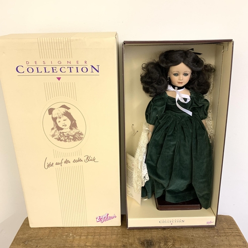 202 - A boxed 'Curzon Collection' porcelain head doll together with a boxed 'Designer Collection' porcelai... 