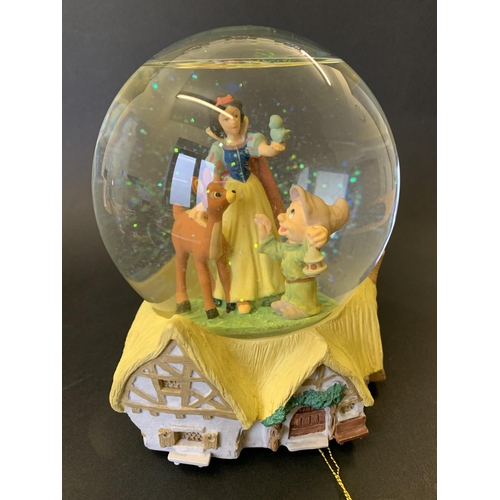 205 - A Disney Store Snow White musical snow dome together with seven Malaysian Disney ceramic dwarfs and ... 