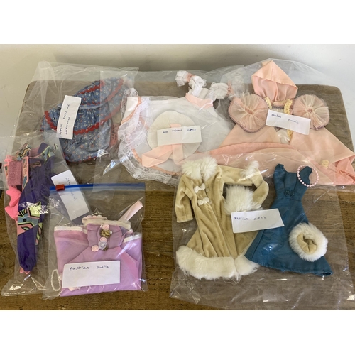 211 - A large box of vintage 1990's Barbie clothes and accessories to include Barbie sun lounger etc