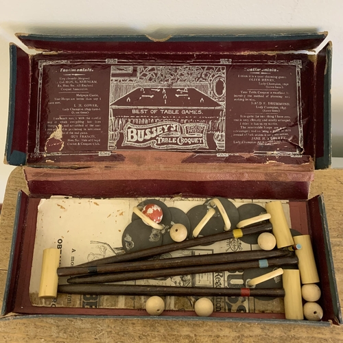 265 - A small box of mixed items of interest including vintage 'Busseys' table croquet, white metal paraso... 