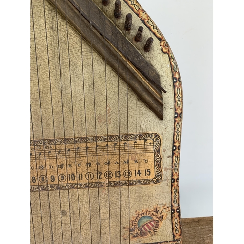 299 - An antique wooden lap Dulcimer harp (a few strings missing, age wear)