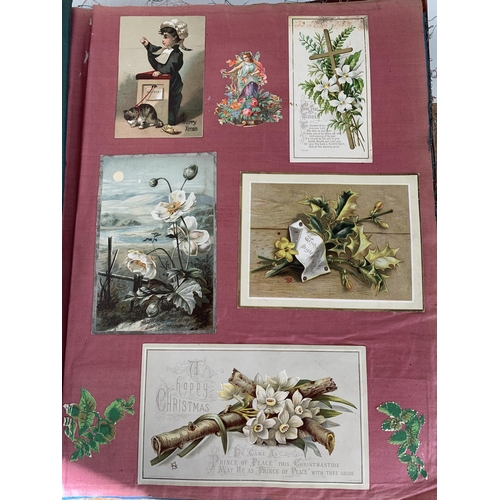 301 - A well filled Victorian/Edwardian scrap book with silk pages to include postcards, Christmas cards, ... 