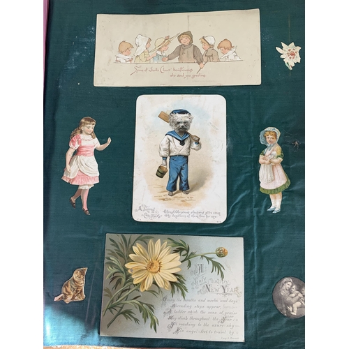 301 - A well filled Victorian/Edwardian scrap book with silk pages to include postcards, Christmas cards, ... 