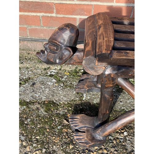 318 - A unusual wooden carved African style bench with heads at each end, 50