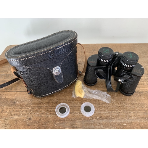 324 - A cased pair of 'Green Kat Deluxe' 8x30 binoculars, clear optics plus a vintage Kodak Brownie 127 ca... 