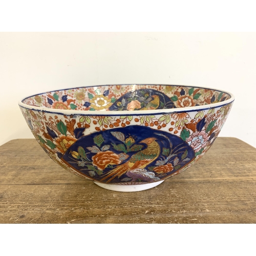 70 - A very large vintage Oriental ceramic hand painted bowl decorated with birds and flowers, Oriental c... 