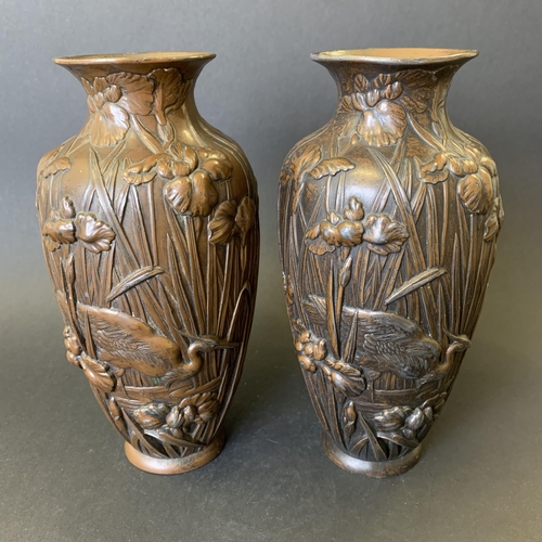 72 - A pair of vintage bronzed metal vases decorated with storks in reeds, approx. 7 3/4