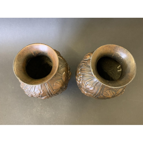 72 - A pair of vintage bronzed metal vases decorated with storks in reeds, approx. 7 3/4