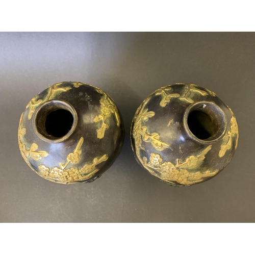 73 - A pair of antique Chinese bronze vases with gold painted decoration highlighting birds in branches, ... 