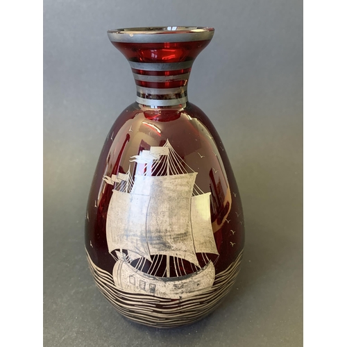 99 - A vintage cranberry glass decanter, hand blown with white metal overlay, 9 1/2