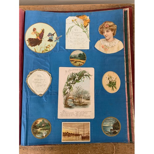 301 - A well filled Victorian/Edwardian scrap book with silk pages to include postcards, Christmas cards, ... 