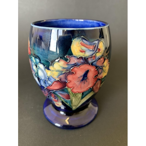 11 - A vintage Moorcroft beaker vase in the 'Iris' pattern with blue base mark, approx. 4