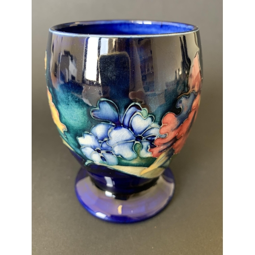 11 - A vintage Moorcroft beaker vase in the 'Iris' pattern with blue base mark, approx. 4