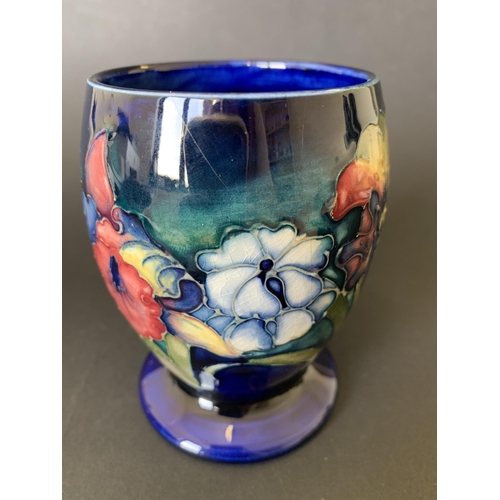 11 - A vintage Moorcroft beaker vase in the 'Iris' pattern with blue base mark, approx. 4